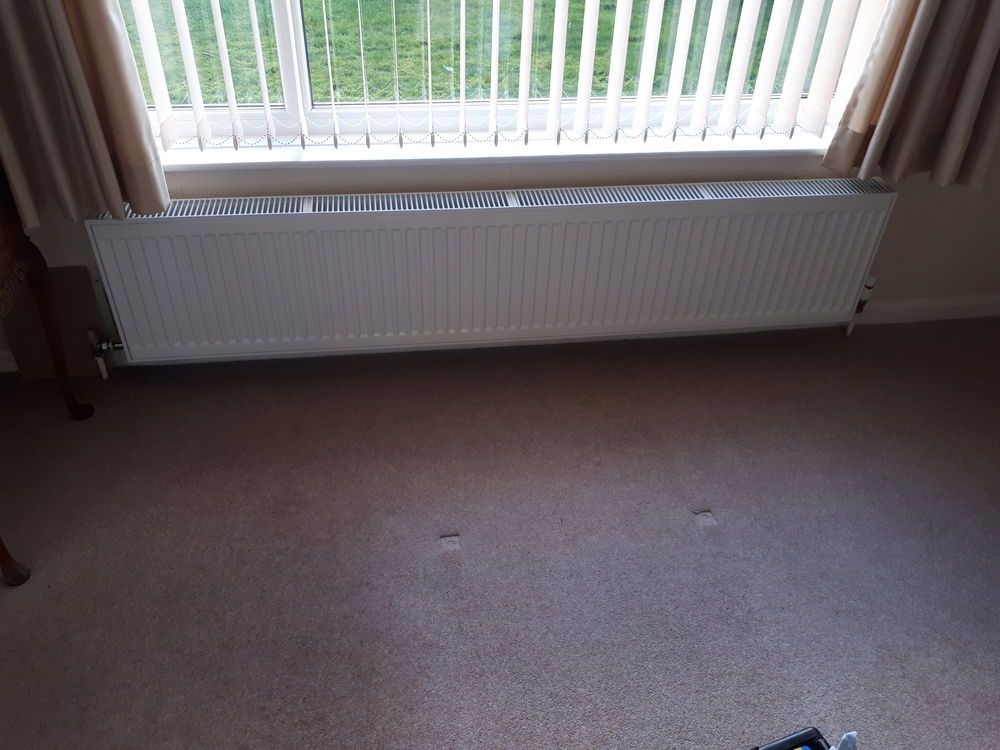 Panel radiator fitted under a window