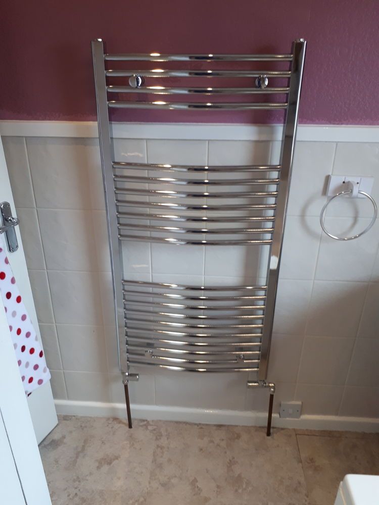 Chrome towel rail radiator in a bathroom