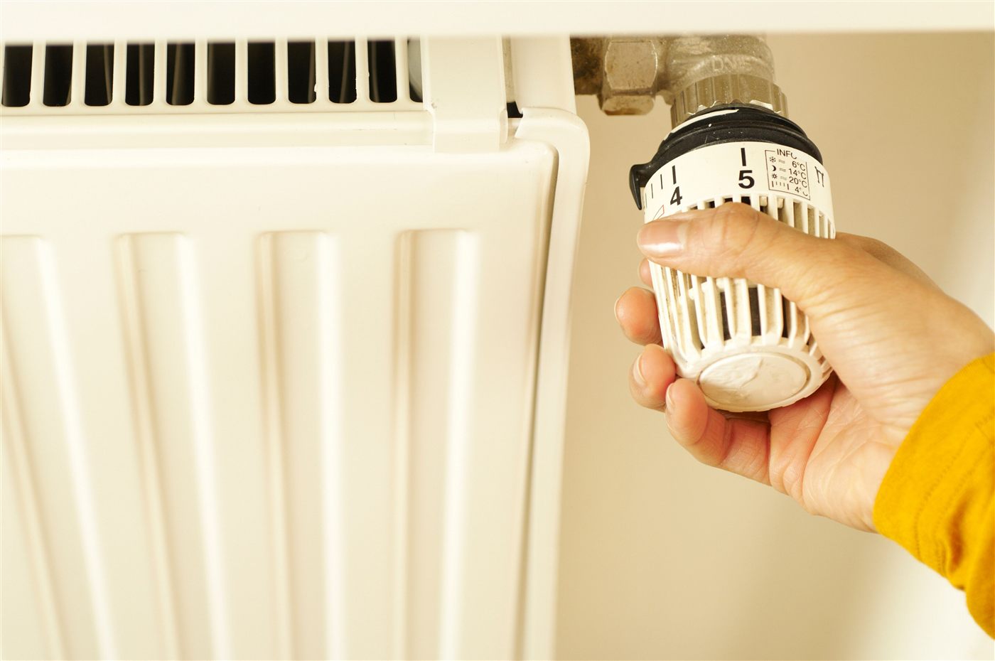 Hand adjusting a thermostatic radiator valve
